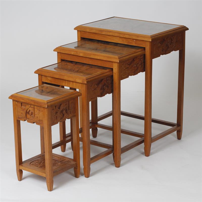 Appraisal: Asian Wood carved nesting tables with carved scenic tops under