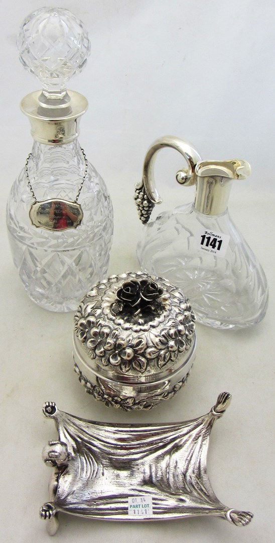 Appraisal: A Sterling mounted glass claret jug the handle terminal formed