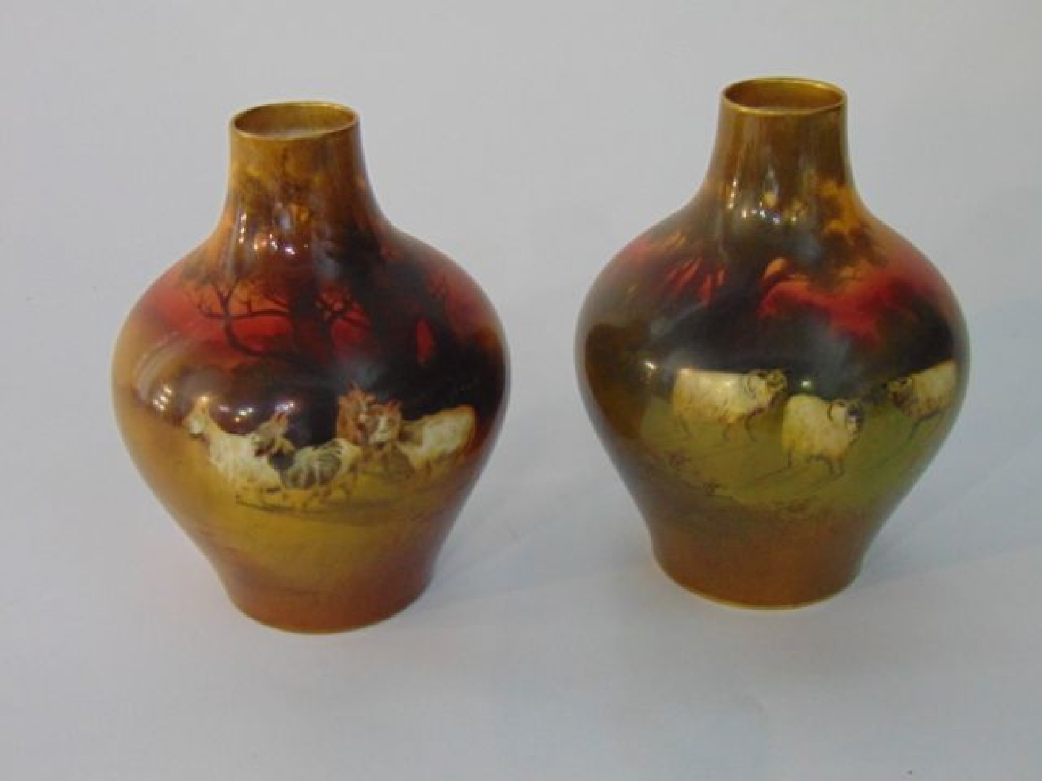 Appraisal: A pair of Royal Doulton vases with printed and infilled