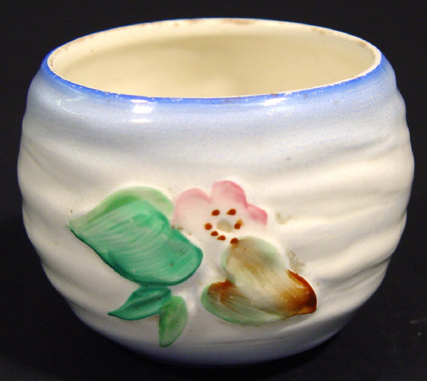 Appraisal: Clarice Cliff sugar bowl relief moulded and hand painted with