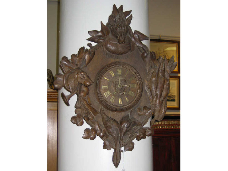 Appraisal: BLACK FOREST CARVED GAME WALL CLOCK Finely detailed face centers