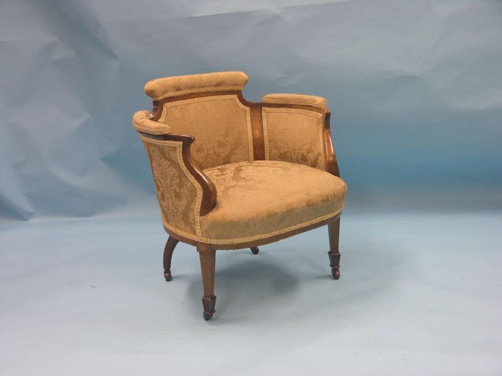 Appraisal: An Edwardian inlaid mahogany nursing armchair upholstered in a gold