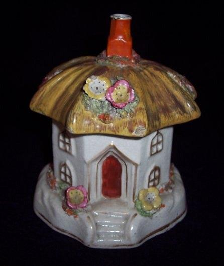 Appraisal: A Staffordshire pastille burner an octagonal cottage with thatched roof