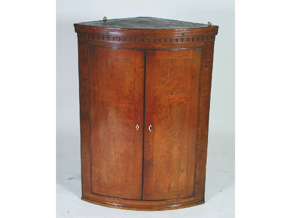 Appraisal: EARLY NINETEENTH CENTURY FIGURED MAHOGANY AND WALNUT BOW FRONT CORNER