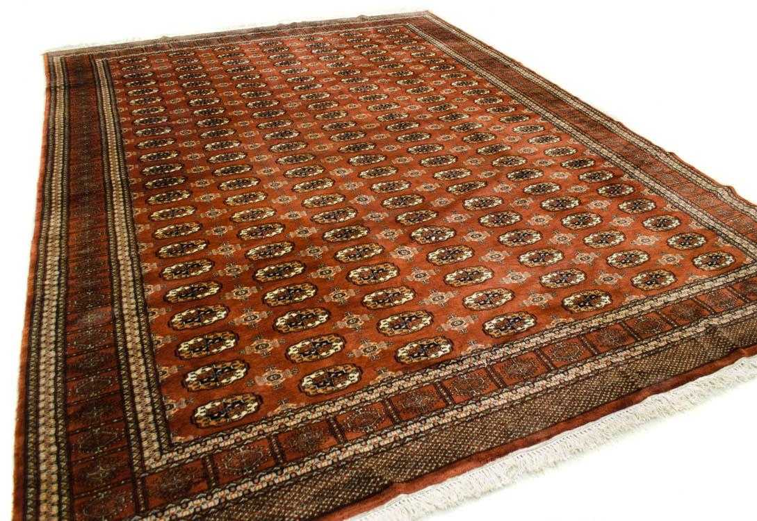 Appraisal: DOUBLE-BASE PAKISTANI BOKHARA CARPET repeating Turkoman gol design on brownish