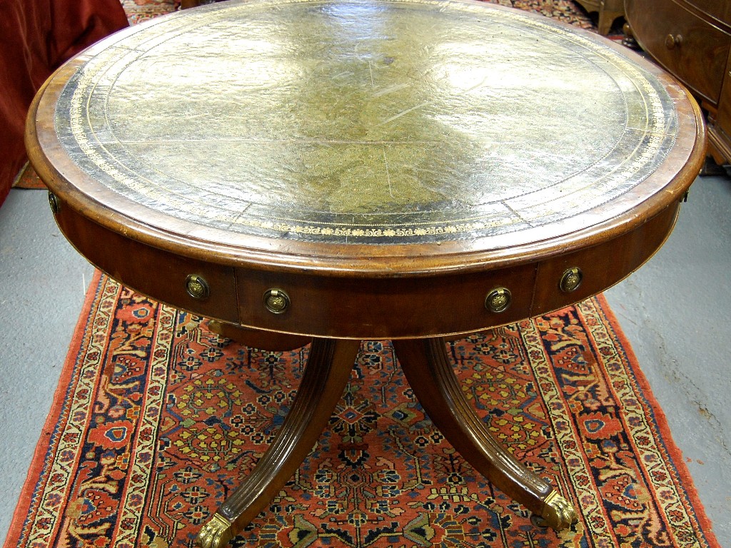 Appraisal: An Edwardian revolving mahogany drum table the circular top having