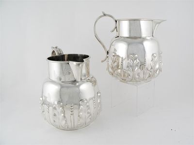 Appraisal: A pair of large Victorian jugs with reeded s-scroll handles