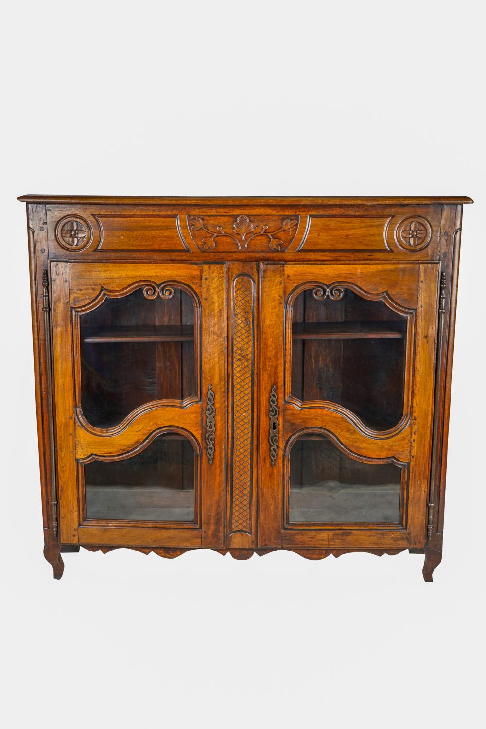 Appraisal: FRENCH PROVINCIAL WALNUT CABINETwith a pair of glazed doors enclosing