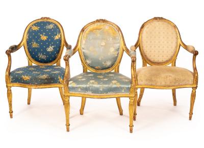 Appraisal: A set of three George III giltwood open armchairs with