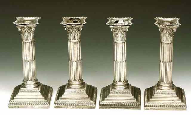 Appraisal: A SET OF FOUR VICTORIAN SILVER CANDLESTICKS corinthian columns standing