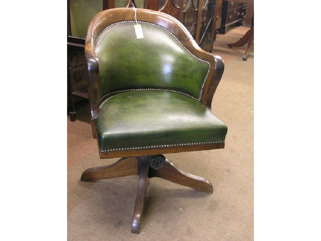 Appraisal: A mid Victorian mahogany-framed office armchair tub shaped back upholstered