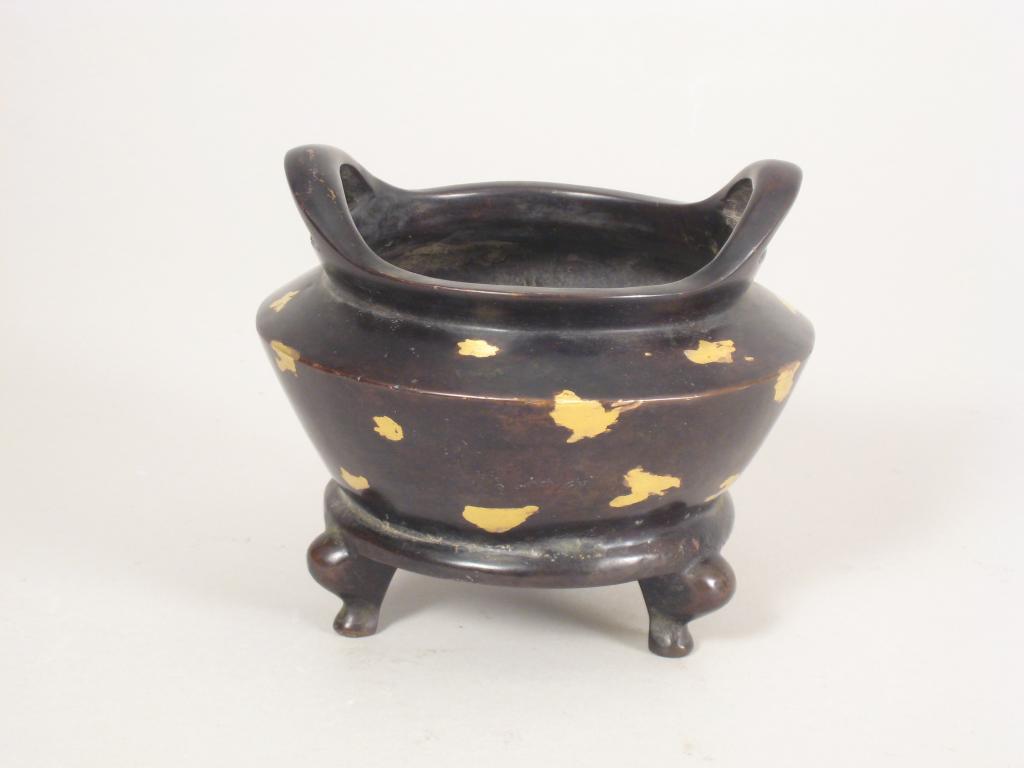 Appraisal: An Oriental two handled bronze Pot with gilt inlay on