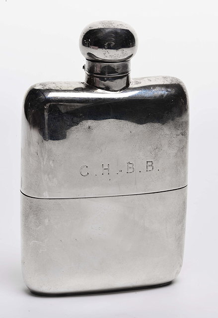 Appraisal: AN EDWARDIAN SILVER HIP FLASK with detachable cup and hinged