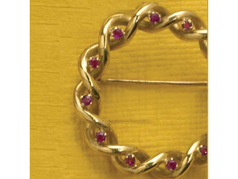 Appraisal: GOLD CIRCLE PIN WITH RUBIES Wreath design with twelve melee