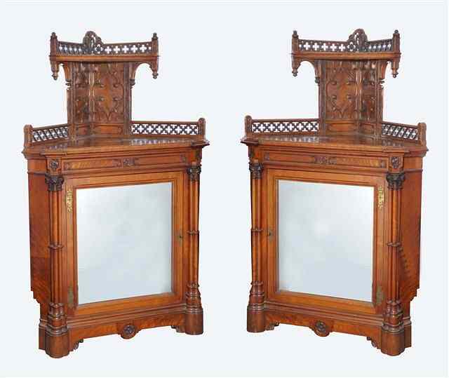 Appraisal: A PAIR OF TH CENTURY GOTHIC REVIVAL WALNUT CORNER CABINETS