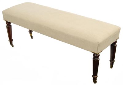 Appraisal: An upholstered rectangular footstool on octagonal legs and brass castors