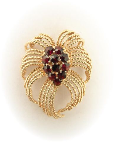 Appraisal: k yellow gold garnet brooch in cascade spray motif with