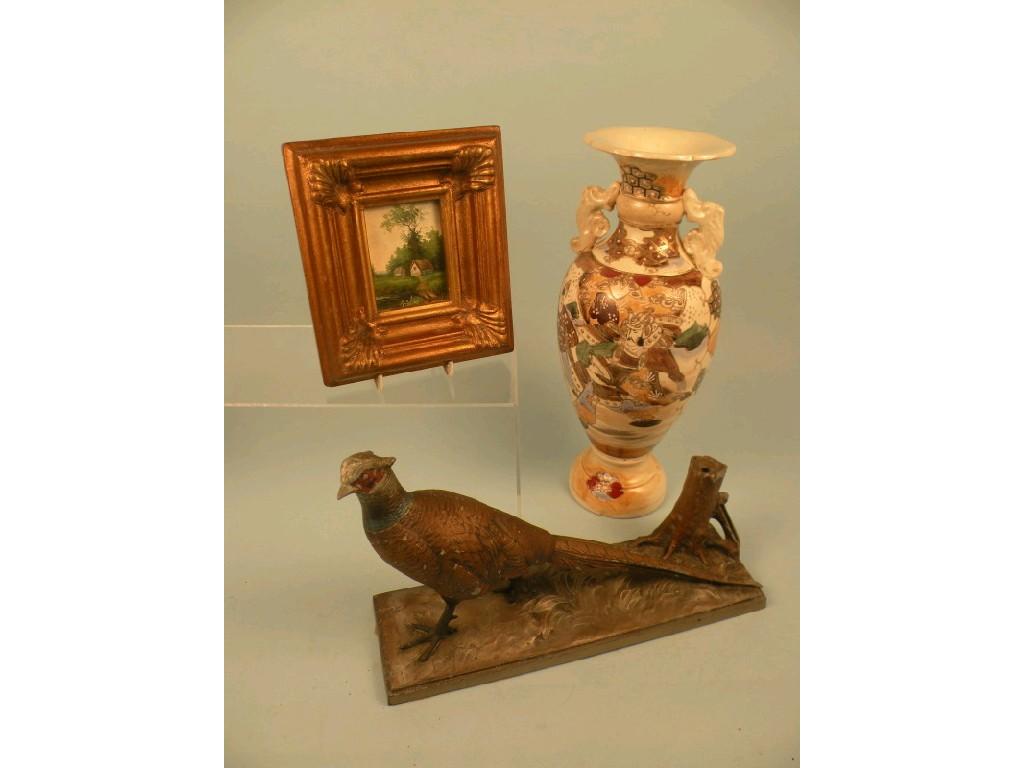 Appraisal: A Spelter table lighter cold painted in the form of