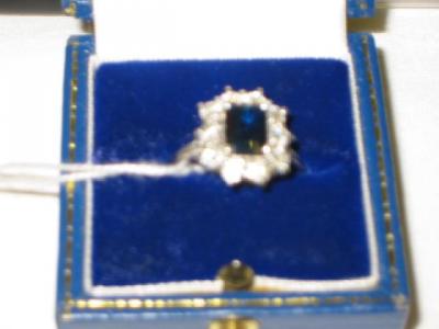 Appraisal: A SAPPHIRE AND DIAMOND CLUSTER RING comprising trap cut sapphire