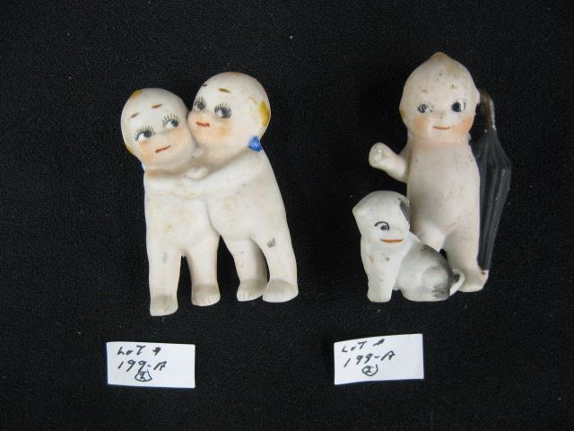 Appraisal: Early Bisque Kewpie Doll Figurines hugging couple and single kewpie