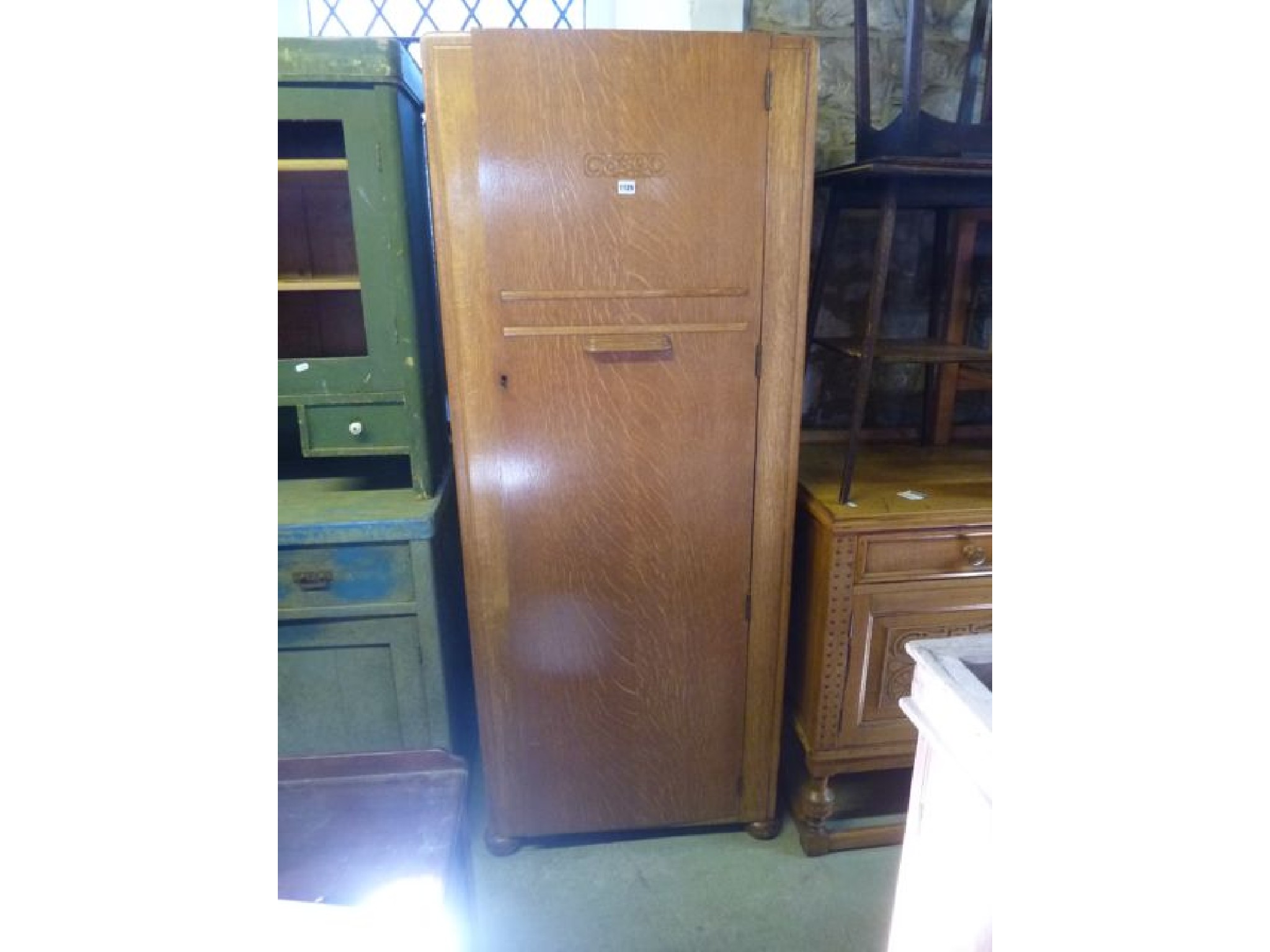 Appraisal: A small Art Deco oak hanging wardrobe cm wide