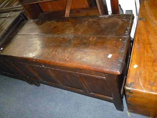 Appraisal: AN OLD OAK COFFER with quadruple panelled front standing on