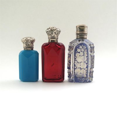 Appraisal: Three mounted coloured glass scents of faceted shouldered form a