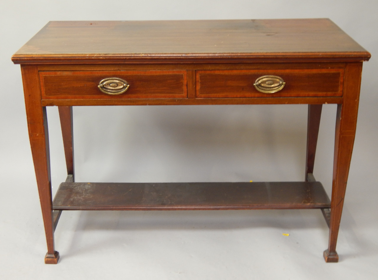 Appraisal: An Edwardian mahogany side table with two crossbanded frieze drawers