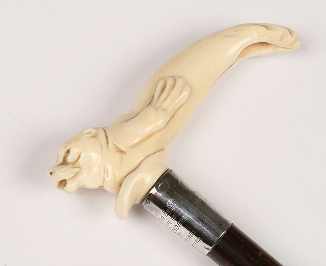 Appraisal: AN IVORY HANDLED WALKING STICK the handle carved in the