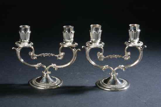 Appraisal: PAIR PERUVIAN STERLING SILVER TWO-LIGHT CANDELABRA Camusso Circular foot supporting