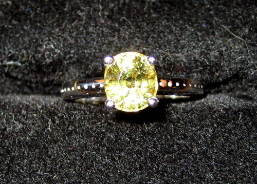 Appraisal: Platinum ring with oval cut demantoid garnet approx mm x