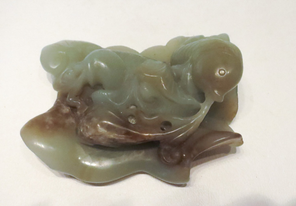 Appraisal: CARVED JADEITE HAND-PIECE depicting fish swimming over a lily pad