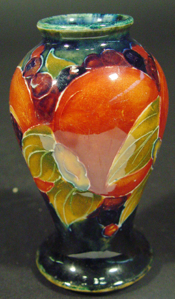 Appraisal: Miniature Moorcroft baluster vase hand painted and tubelined with pomegranates