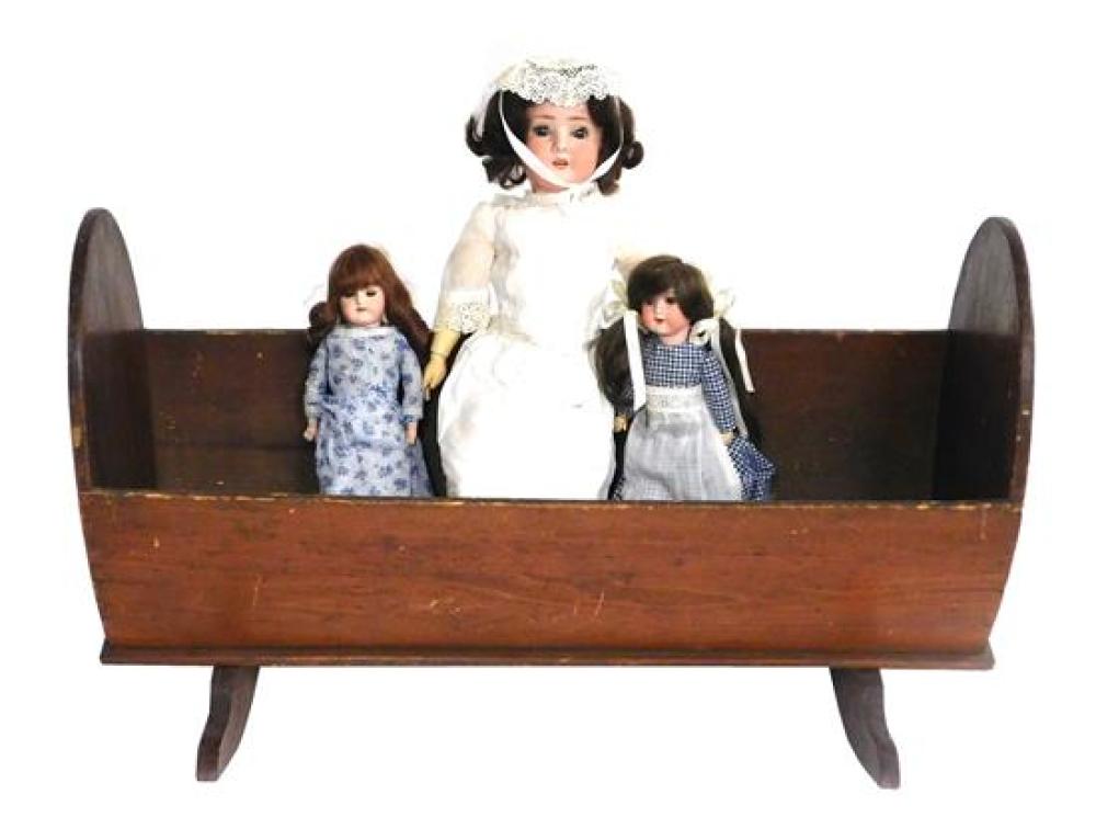 Appraisal: DOLLS th C American cradle and three German bisque head