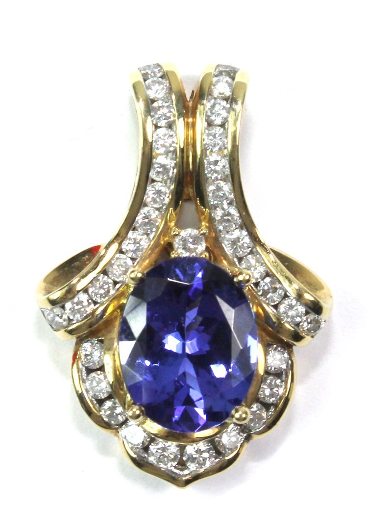 Appraisal: A gold tanzanite and diamond set pendant in a drop