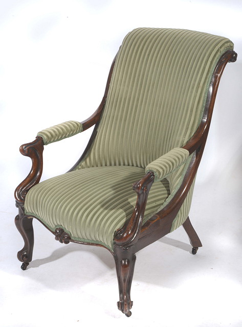 Appraisal: A VICTORIAN MAHOGANY OPEN LIBRARY ARMCHAIR the carved scrolling frame