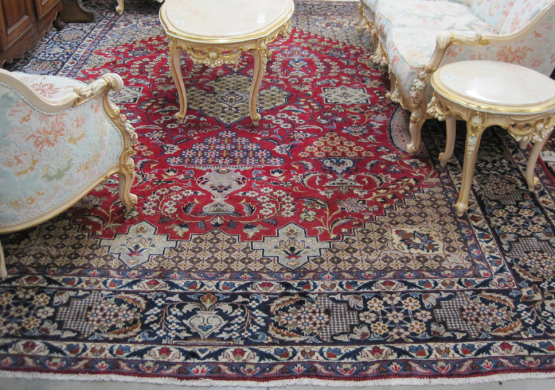 Appraisal: HAND KNOTTED PERSIAN CARPET overall floral design on red ground