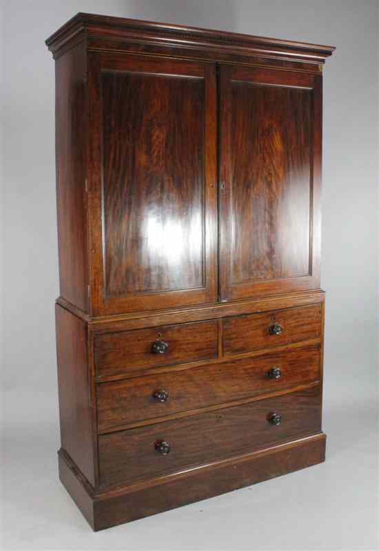 Appraisal: A George III mahogany linen press with two panelled doors