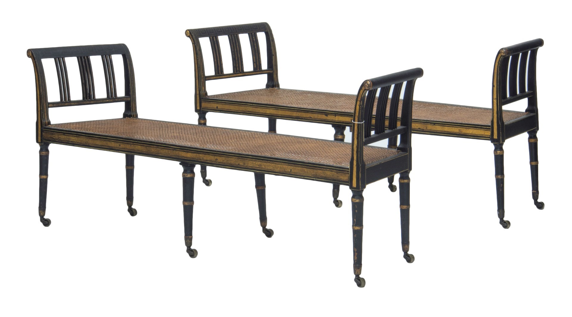 Appraisal: A pair of Regency parcel gilt ebonised window seats of