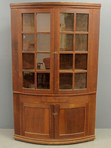 Appraisal: - Southern cherry and yellow pine two-part bow-front corner cupboard