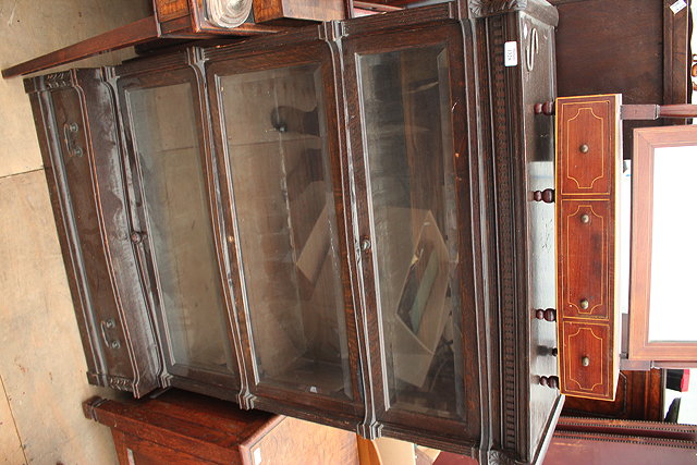 Appraisal: AN OAK GLOBE-WERNICKE BOOKCASE with three glazed doors over a