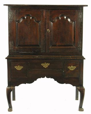 Appraisal: An oak cabinet on stand the bordered top with cleated