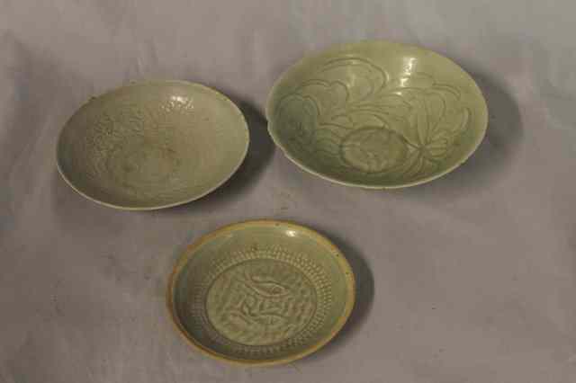 Appraisal: A CHINESE TING WARE RELIEF MOULDED CIRCULAR BOWL and two