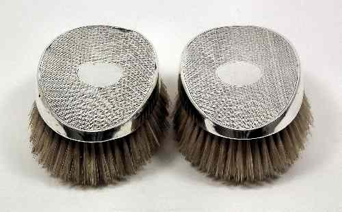 Appraisal: A pair of George V silver backed oval clothes brushes