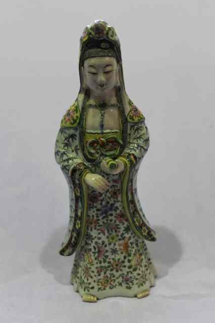 Appraisal: A CHINESE PORCLEAIN MODEL of Guanyin holding a scroll decorated