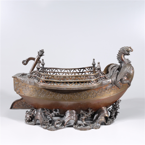 Appraisal: Intricate Japanese bronze boat with phoenix prow amidst molded waves