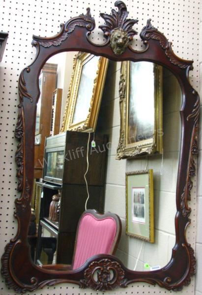 Appraisal: A decorator-quality wall mirror with carved wooden frame having gilded