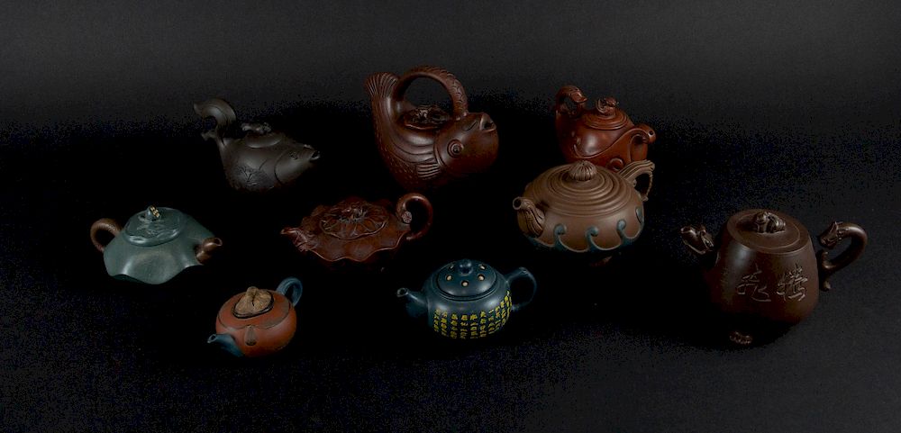 Appraisal: A Group of Yixing Teapots Chinese Including two fish-form pots