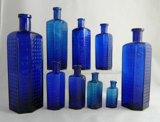 Appraisal: Poison cobalt irregular hexagonal bottles Poison- cobalt irregular hexagonal bottles