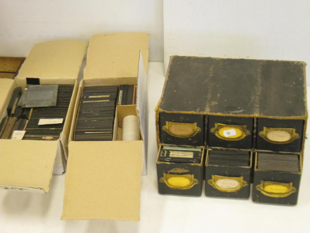 Appraisal: A cabinet of coloured and monochrome Lantern Slides together with